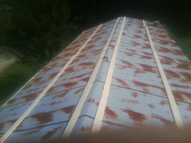Rusted metal roof panels with new wood purlins before replacement — Storm Damage Roof Repair in Scott Depot by Roofing Brothers