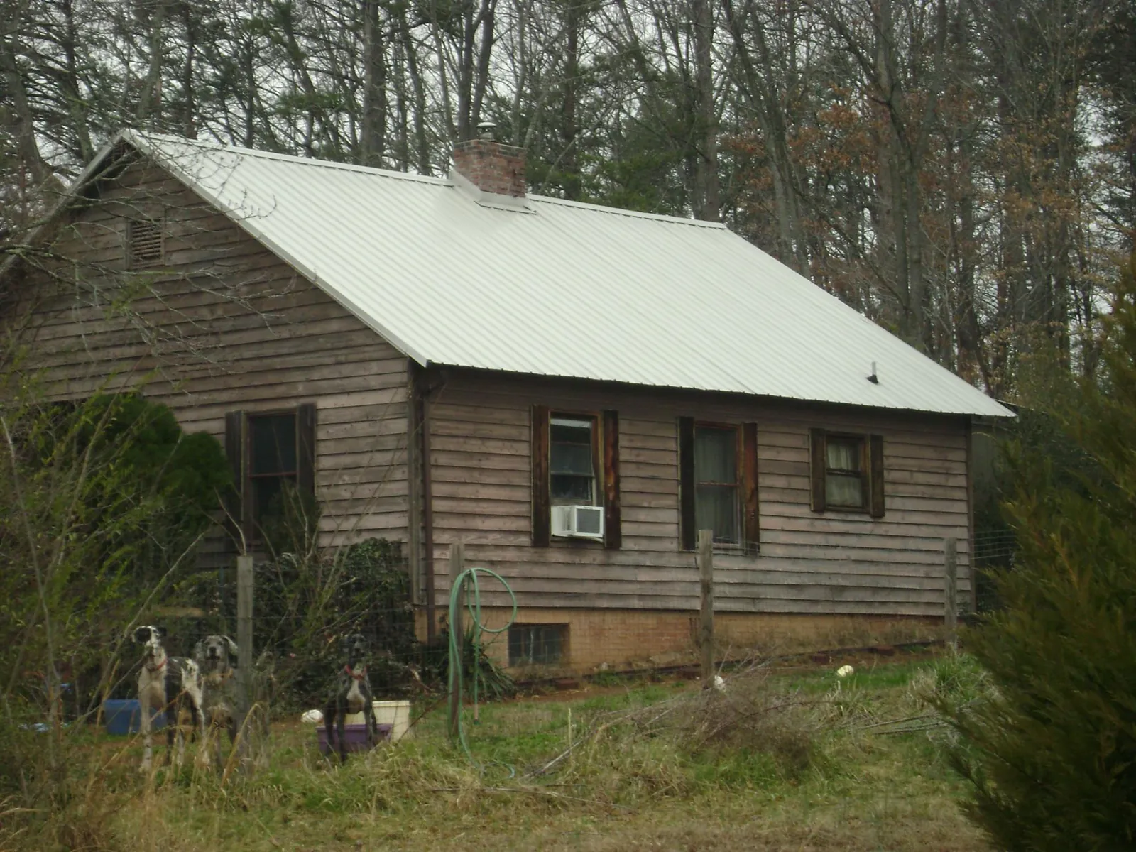 White metal roof on an old wood sided farmhouse, from a Metal Roof Installation job in Scott Depot